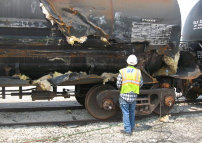 damaged tank car in rail yard