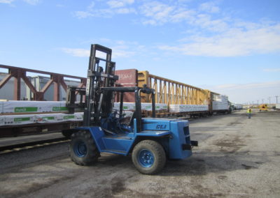 forklift unloading train cargo at rail yard